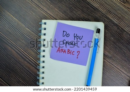 Concept of Do You Speak Arabic? write on sticky notes isolated on Wooden Table.