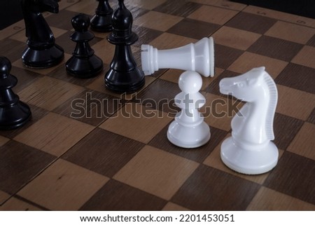 Logic board game. The pieces are black and white on an old chessboard. Strategy moves to win. Can be used as a background in a presentation.
