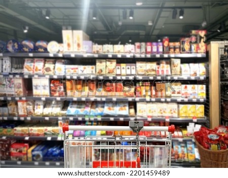 Choosing food from shelf in supermarket,vegetables in grocery section,Grocery stores ,empty grocery cart in an empty supermarket Royalty-Free Stock Photo #2201459489