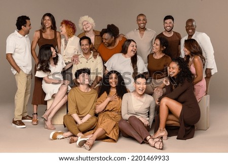 Studio shot of a group of beautiful multiethnic people laughing together on a neutral background. Royalty-Free Stock Photo #2201469933