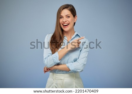 Smiling woman pointing finger. Isolated portrait female business person. Royalty-Free Stock Photo #2201470409