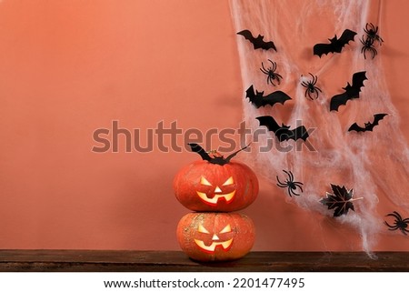 Happy halloween concept, background with pumpkins, spiders and bats in the web with place for text, greeting card or banner, template for design, selective focus