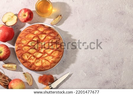 Kitchen background with apple pie, honey, apples, spices, cozy warm concept, hello autumn, hygge style, modern bakery advertisement, selective focus, top view, space for text,