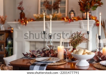 Dinner table decorated for cozy fall holiday gathering Royalty-Free Stock Photo #2201477791