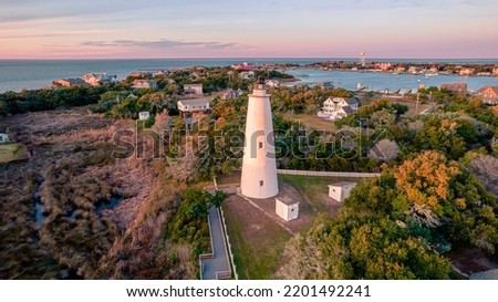 Ocracoke Lighthouse on Ocracoke , North Carolina at sunset.The lighthouse was built to help guide ships through Ocracoke Inlet into Pamlico Sound. Royalty-Free Stock Photo #2201492241