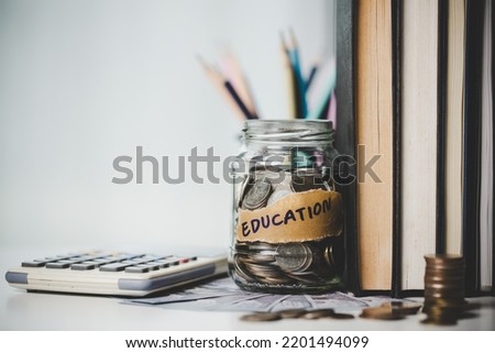 close-up education object with stack money coin-cash dollar and glass jar on background. Concept to saving money income for study, Calculating student finance costs and investment budget loan