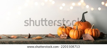 Mini Pumpkins And Leaves On Wooden Table With Bokeh Lights - Autumn And Thanksgiving Decoration