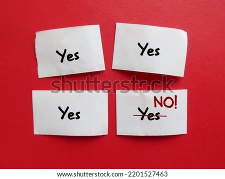 Pieces of paper with handwriting YES YES YES and last one changed to NO, concept of people pleaser try not to feel guilty about saying no, no need to agree or say yes to everything Royalty-Free Stock Photo #2201527463