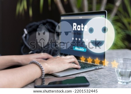 Online review rating women using laptop puts online rating. Five star rating. Rating star concept with woman using a laptop computer