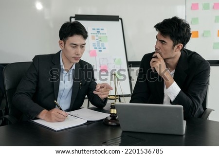 Lawyers sit for a meeting with the team at the law firm.