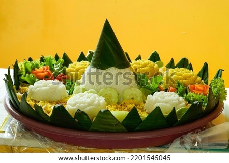 Tumpeng nasi kuning.Nasi Tumpeng Kuning. The yellow rice in cone shape; a festive Indonesian rice dish presentation