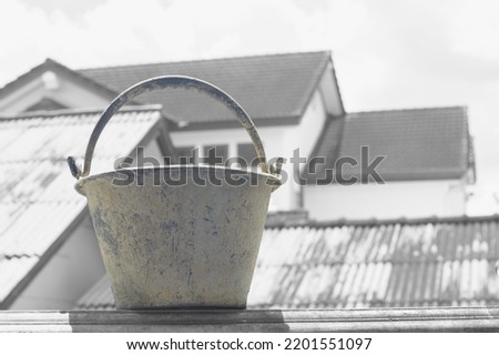 Plastic cement bucket on natural light background. High key photography.