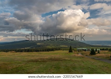 Cerna hill in summer color evening with some white clouds in Krkonose mountains