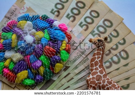 many 500 hryvnia with colored pebbles, shells and symbols of travel and exotic recreation