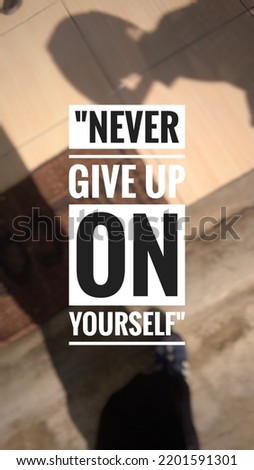 Inspirational quotes "Never give up on yourself" in floor background