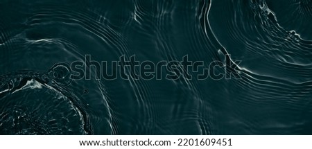 Black transparent clear calm water surface texture with ripples, splashes. Abstract nature banner background. Dark grey water waves. Copy space, top view. Cosmetic moisturizer micellar toner emulsion Royalty-Free Stock Photo #2201609451