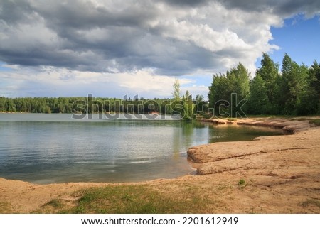Landscape with sandy lake shore on a summer day. Royalty-Free Stock Photo #2201612949