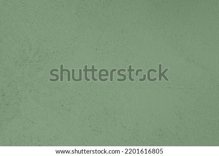 Saturated pastel warm gray green colored low contrast Concrete textured background. Empty colourful wall texture with copy space for text overlay and mockups. 2023, 2024 color trend Royalty-Free Stock Photo #2201616805