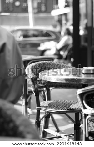 Paris, France. Blurry Abstract French Cafe View. People Relaxing at the Cafe. Iconic Parisian Cafe Terrace Black and White View.