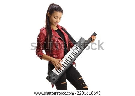Female musician in a leather jacket playing a keytar isolated on white background