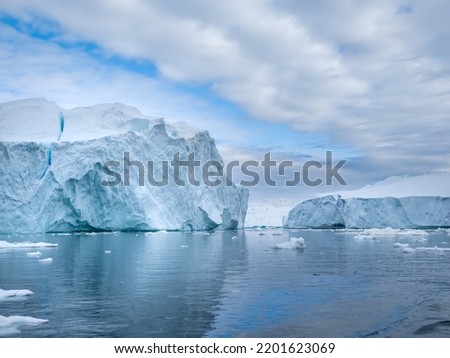 Awe-inspiring icy landscapes at the mouth of the Icefjord glacier (Sermeq Kujalleq), one of the fastest and most active glaciers in the world. Disko Bay, Ilulissat, Greenland Royalty-Free Stock Photo #2201623069