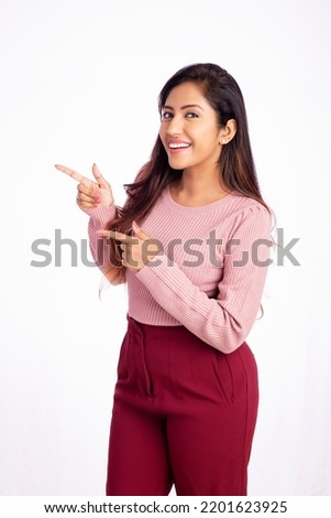 Young business woman pointing side isolated on white. Royalty-Free Stock Photo #2201623925