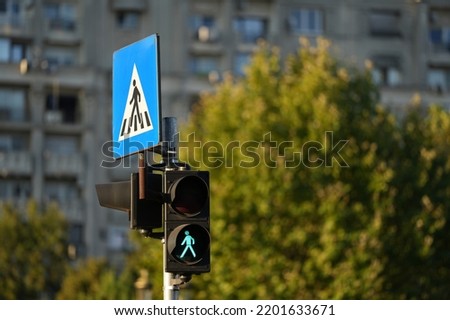 Pedestrian traffic light sign in green color showing that you are allowed to cross the street. 4k video, public transportation industry.