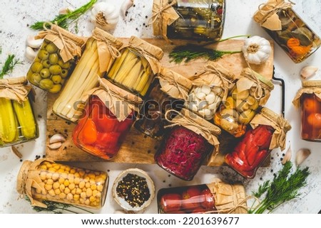 Cucumber, pepper, tomatoes, mushrooms pickling and canning into glass jars. Ingredients for vegetables preserving Royalty-Free Stock Photo #2201639677