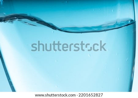 blue splash of water in a glass vessel. High quality photo