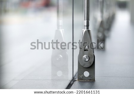 Closeup Stainless fasteners elements of glass curtain walls system. Royalty-Free Stock Photo #2201661131