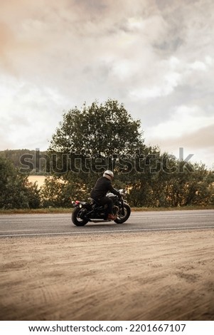 Photo of a motorcyclist on the road. Lifestyle wallpaper. Voyage
