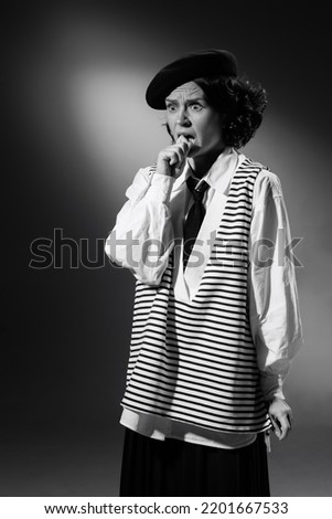 Portrait of beautiful artistic woman in stylish classical clothes posing, showing acting skills, emotions of shock. Black and white photography. Monochrome effect. Concept of fashion, style, history