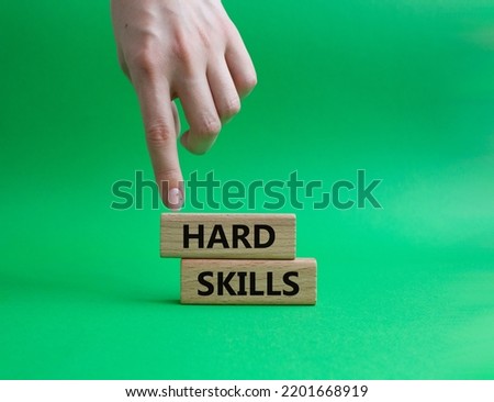 Hard skills symbol. Wooden blocks with words Hard skills. Beautiful green background. Businessman hand. Business and Hard skills concept. Copy space.