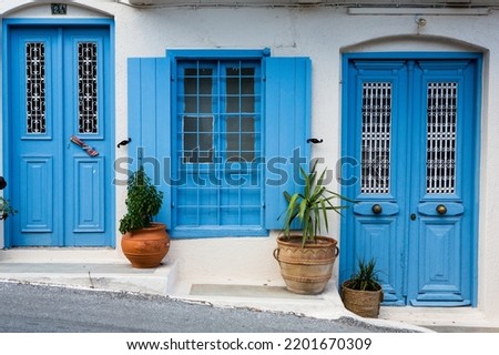 Narrow and colorful street in the village of Kritsa in the island of Crete. White street, beautiful traditional housing in Greece.  Royalty-Free Stock Photo #2201670309