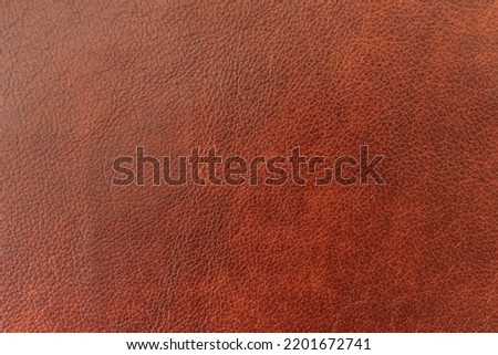 Texture of genuine leather close-up, brown color, background, pattern for backdrop. Manufacturing of leather accessory concept Royalty-Free Stock Photo #2201672741