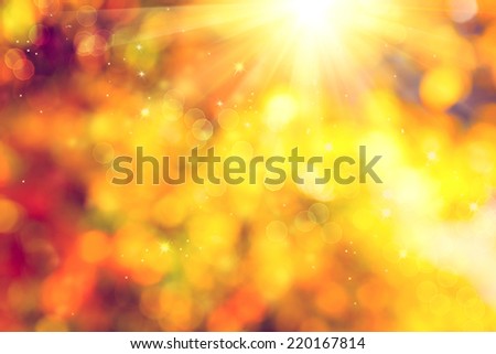 Autumn. Blurred Fall Abstract autumnal background with colorful leaves and sun