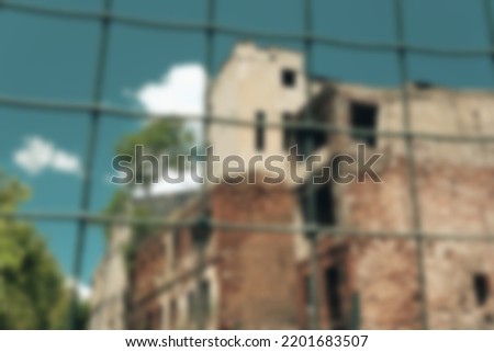 Blurred background Old brick building behind of wire fence, open cloudy sky, retro color palette, Eminonu karakoy old streets and structures, building about to be demolished, selective focus