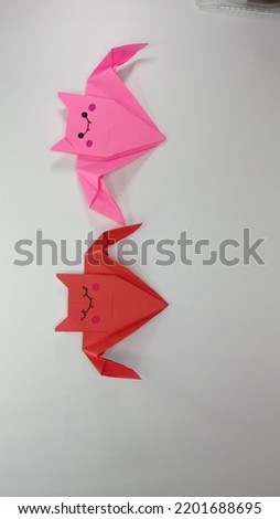 a photo of a bat-shaped origami toy. made in various colors