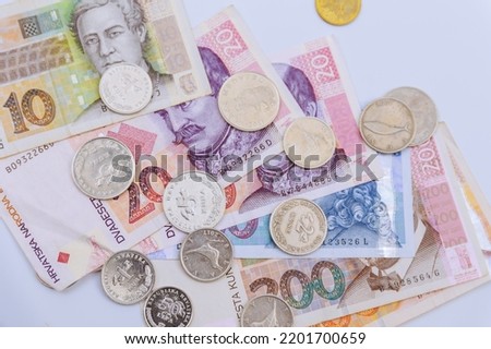 Croatian kunas and coins of different denominations on a white background. Croatian money. Royalty-Free Stock Photo #2201700659