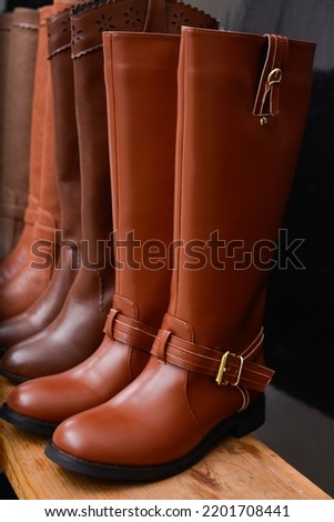 womens boots on the shelves in the store.