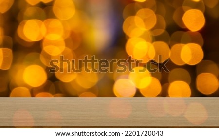 Blank Wooden Table with Orange Red Bokeh on Black Background,Golden Light Night Blur Circle Effect Sparkle,Card Poster,Empty Floor Counter for Presentation of Merry Christmas and Happy New Year 2023.