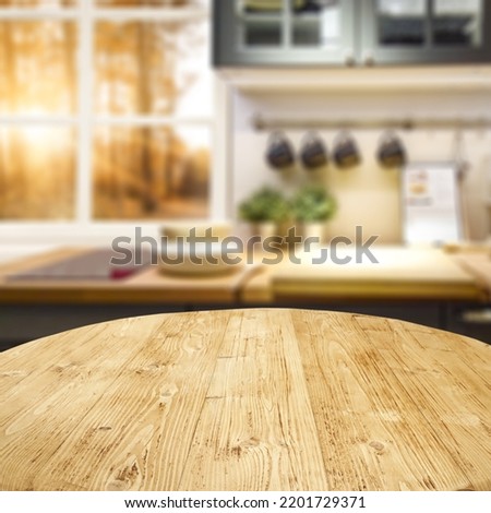 Wooden desk of free space and kitchen interior. Royalty-Free Stock Photo #2201729371