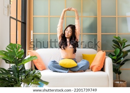 Young smiling women chill  relax raise arm after working and meeting at home.  Lifestyle freelance happy and drinking coffee in luxury living room in vacation holiday and summer day.  Lifestyle