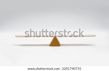 Empty seesaw balancing on white background.
