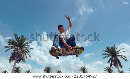 Skateboarder doing a trick in a skate park Royalty-Free Stock Photo #2201764927