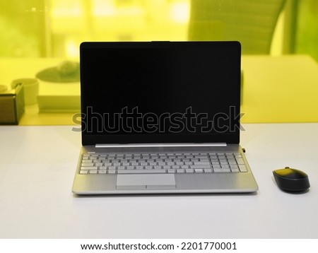 This is the Picture of a Grey Laptop with a mouse.