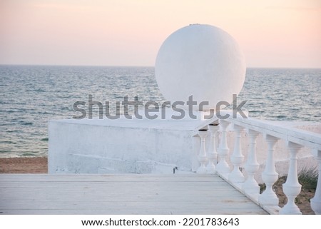 balloon on the balustrade on the beach at sunset