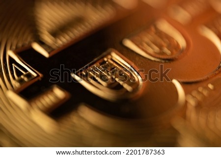 top view extreme macro closeup of of the B letter on crypto bitcoin golden coin logo with shallow depth of field