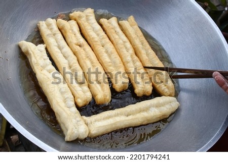 Cakwe aka You Tiao is Chinese traditional food, i.e. long striped dough on frying 
