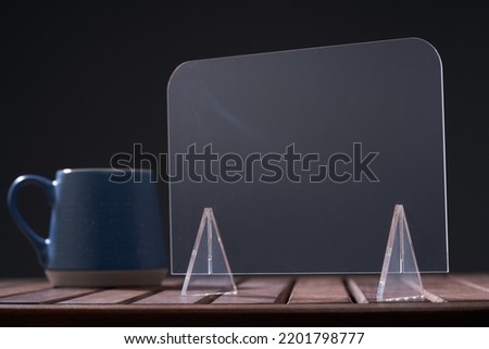 cup of coffee and blank transparent retail display for copy space